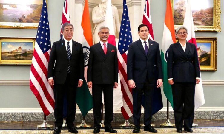 Four men pose for a photo