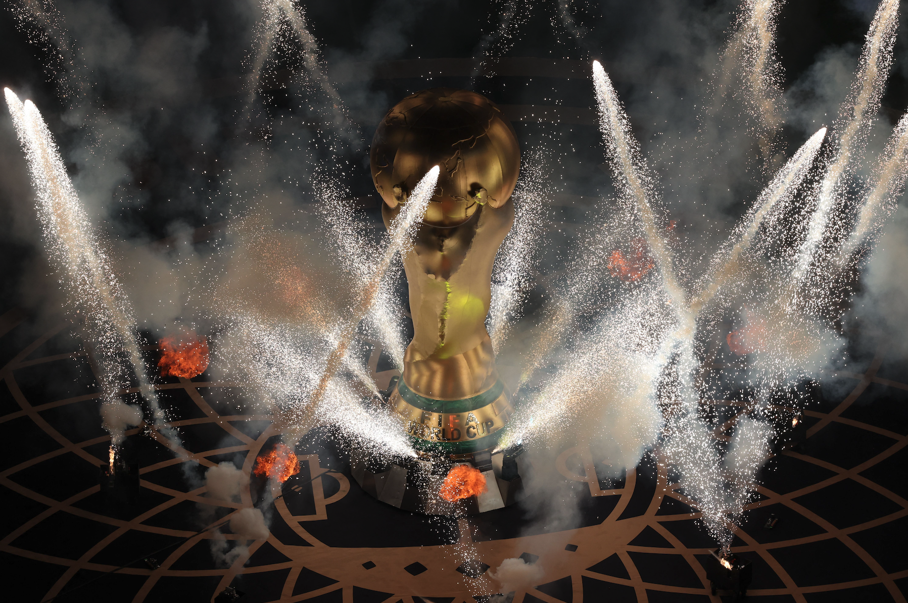 FIFA World Cup trophy surrounded by fireworks